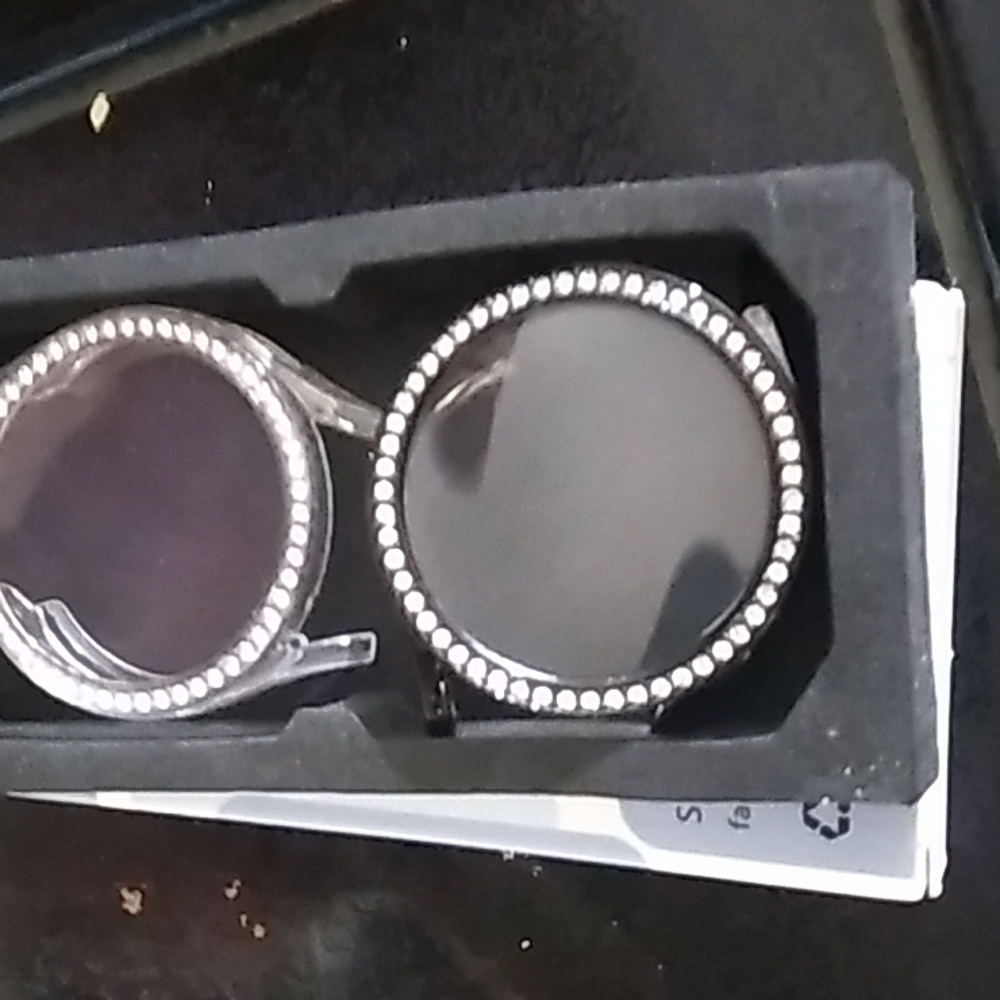 Two watch face casings encased with faux diamonds
